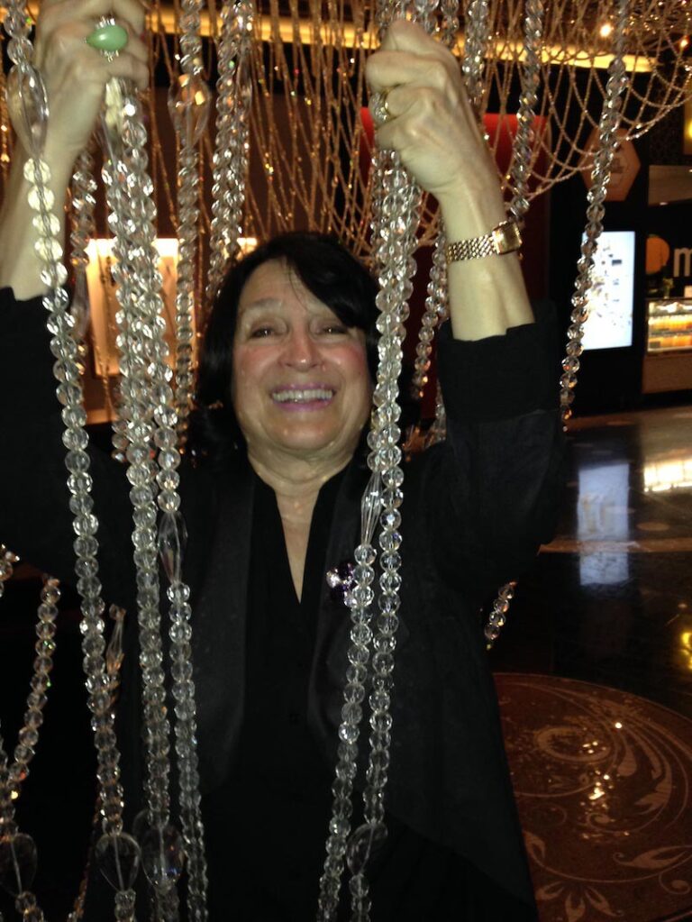 Woman in black holding crystal links