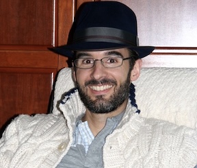 Christmas-2010-Photos-16 Man with a bear, glasses and black hat.