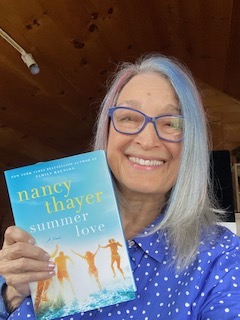 Nancy Thayer holding the book Summer Love.