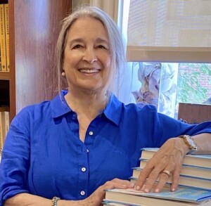 Nancy Thayer Leaning on books.