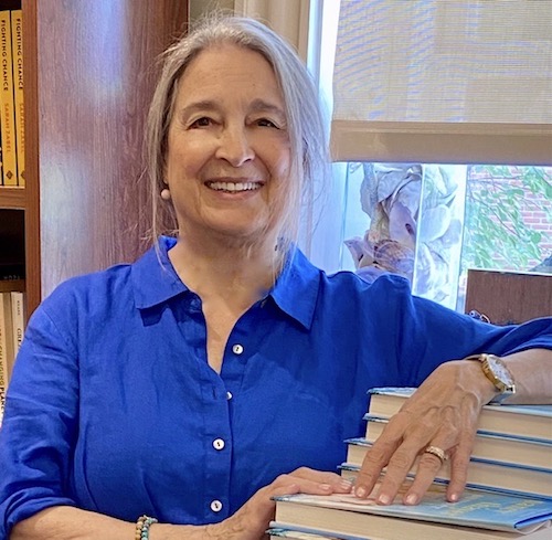 Nancy Thayer Leaning on books.